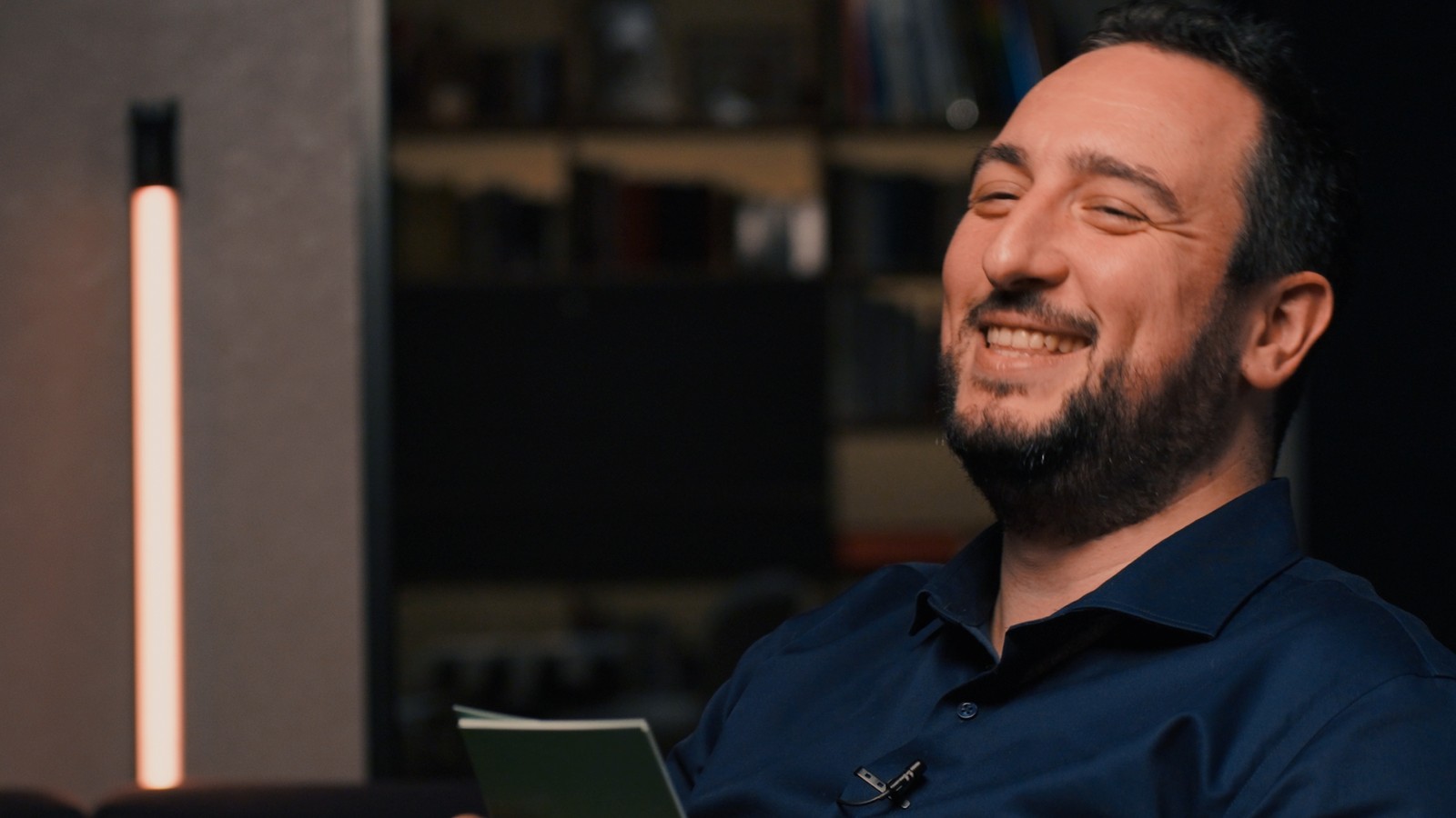 Tony Loeb, co-founder of 10minutes.news, laughing with a notebook during his cover story interview